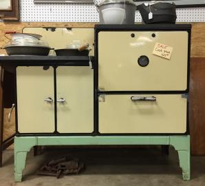 This antique stove would be perfect in a retro kitchen! The colouring is great, and the inside needs a little work.